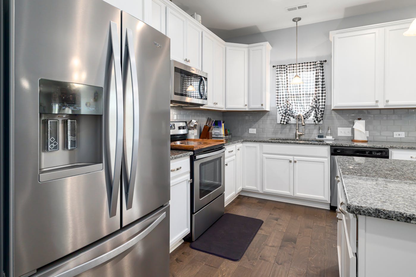 Finished kitchen remodel with bright cabinetry and counters